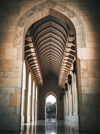 A series of islamic architectural style arches at a hallway. sultan qaboos grand mosque. muscat