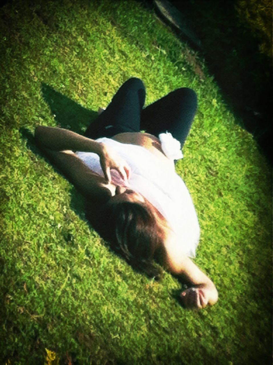 grass, lifestyles, leisure activity, grassy, field, person, casual clothing, relaxation, young adult, sunlight, high angle view, lying down, young women, sitting, portrait, day, front view, looking at camera