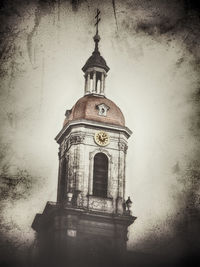 Low angle view of tower and building against sky