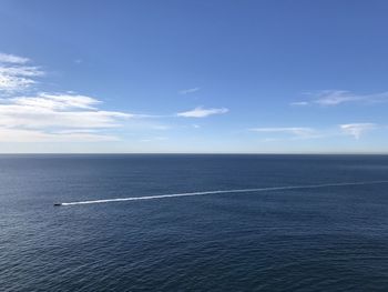 Scenic view of sea against blue sky