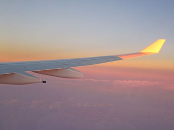 Cropped image of airplane flying over clouds