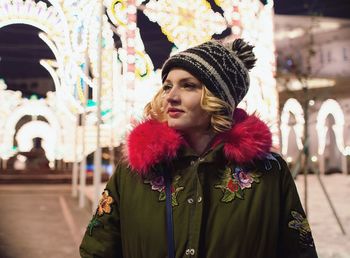Portrait of young woman looking away outdoors