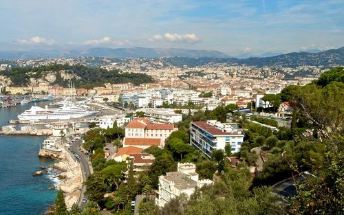 High angle view of townscape by sea against sky