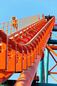 Row of red flags against clear blue sky