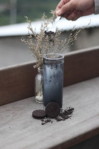 Close-up of hand preparing drink on table