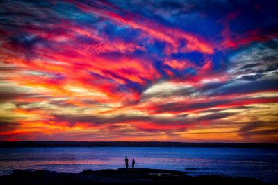 Scenic view of dramatic sky over sea during sunset