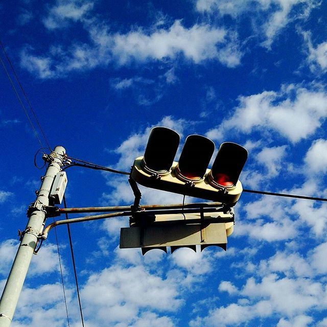 low angle view, sky, electricity, power line, cable, blue, technology, power supply, cloud - sky, fuel and power generation, cloud, lighting equipment, outdoors, no people, cloudy, connection, power cable, day, street light, electricity pylon