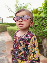 Portrait of boy wearing eyeglasses standing outdoors