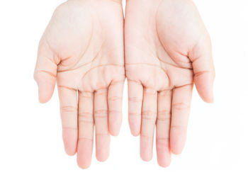 Close-up of baby hand over white background