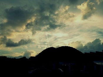 Silhouette of buildings against dramatic sky