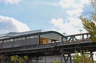 Low angle view of train on bridge against sky