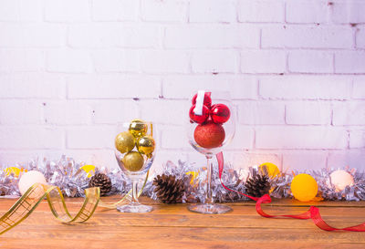 Close-up of fruits on table against wall