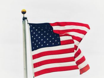 Low angle view of flag against sky