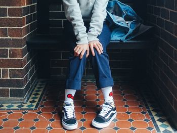 Low section of woman standing on staircase