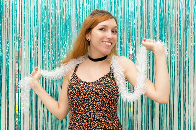 Portrait of woman wearing feather boa by decoration