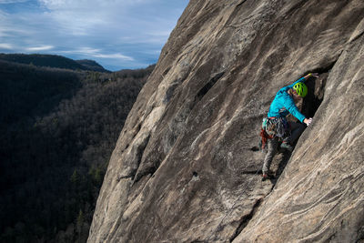 High angle view of man rock climbing against landscape