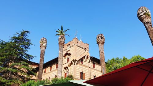 Low angle view of historic building against clear blue sky