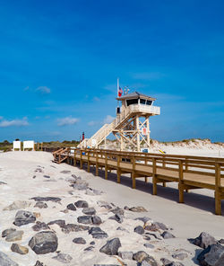 View of beach against blue sky