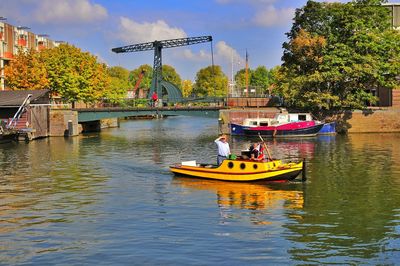 Boats in river with buildings in background