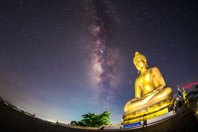 Low angle view of statue against sky at night