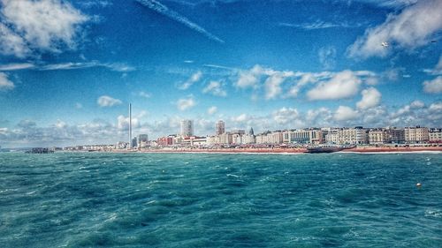 View of harbor against cloudy sky