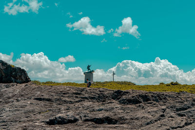 Man standing on field against sky