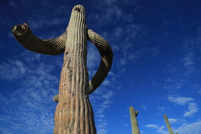 Low angle view of statue against blue sky