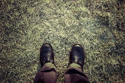 Low section of person standing on tiled floor