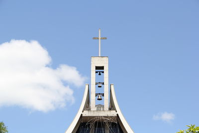 Low angle view of tower amidst buildings against sky