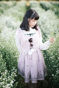 Woman standing amidst plant