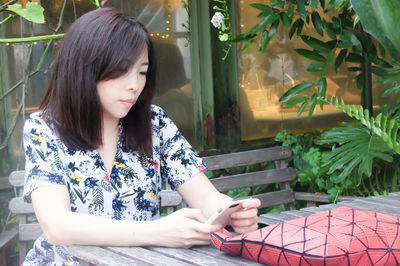 Young woman sitting outdoors