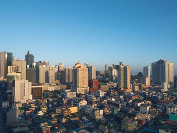 Modern buildings in city against clear sky