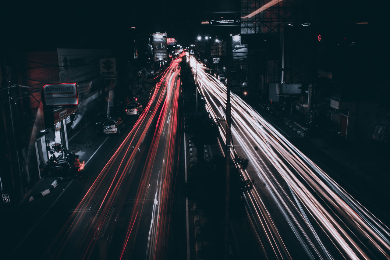 HIGH ANGLE VIEW OF LIGHT TRAILS ON ROAD IN CITY