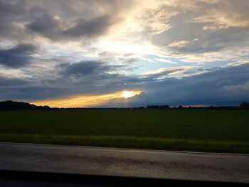 Scenic view of field against sky during sunset