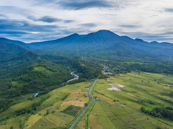 Aerial view of a village in the morning with a river flowing by its side