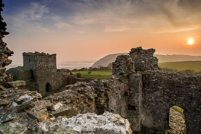 Old ruins of building against sky during sunset