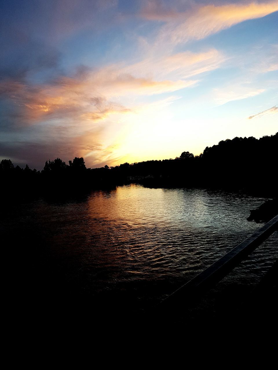 sunset, water, silhouette, scenics, tranquil scene, lake, tranquility, beauty in nature, reflection, calm, sky, nature, idyllic, rippled, cloud, dark, outline, majestic, cloud - sky, outdoors, orange color, countryside, non-urban scene, waterfront, remote, no people, atmospheric mood, dramatic sky, atmosphere, moody sky