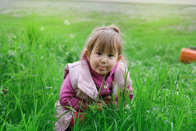 Portrait of cute girl on field