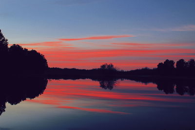 Scenic view of lake against romantic sky at sunset