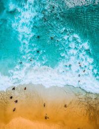 High angle view of people swimming in sea