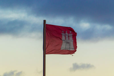 Red flag against sky