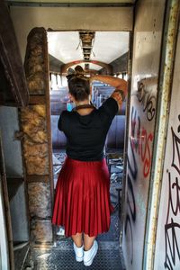 Rear view of woman standing in corridor