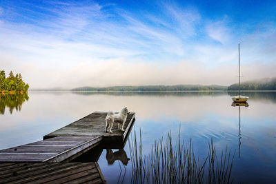 Pier over lake against sky