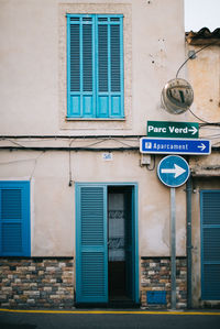 Road sign against building