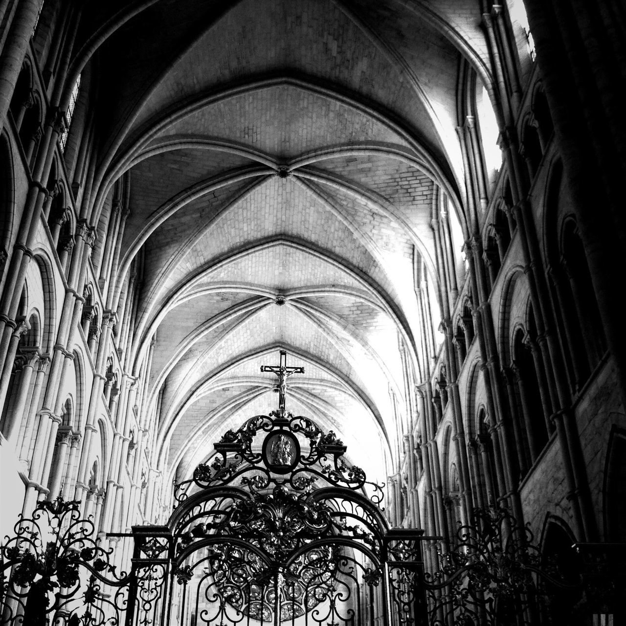 architecture, low angle view, built structure, arch, church, place of worship, religion, indoors, spirituality, ceiling, building exterior, cathedral, architectural feature, interior, illuminated, history, architectural column, no people