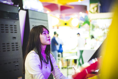 Smiling young woman at amusement arcade