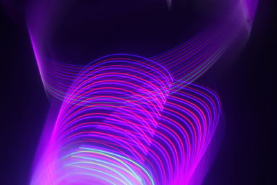 Close-up of light painting against black background