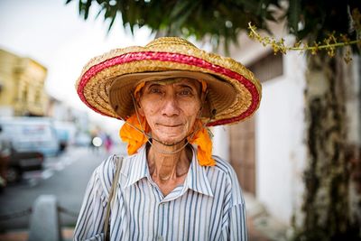 Portrait of man wearing hat standing outdoors