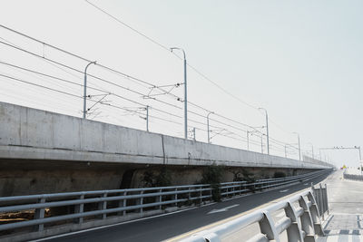 Bridge over road against clear sky