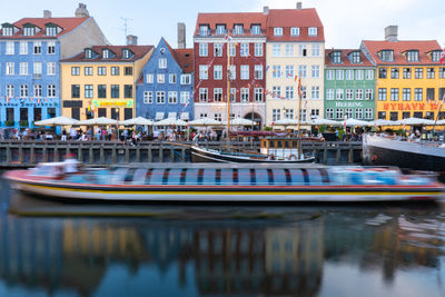 Buildings and boat at nyhavn harbour, copenaghen